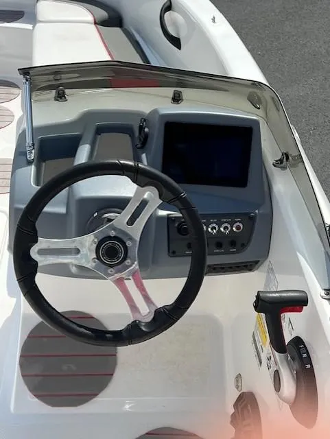 Slide: The Image of 2023 Tahoe T18 boat dashboard with steering wheel and control panel. - 8