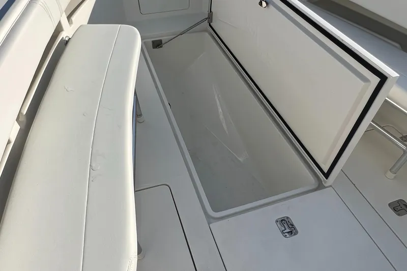 Slide: The Image of 2018 SeaVee 320B boat storage compartment with open lid, showcasing spacious interior. - 12