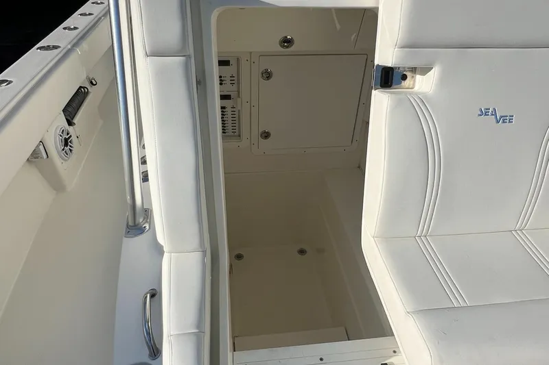 Slide: The Image of 2018 SeaVee 320B boat interior with white seating and storage compartment. - 15