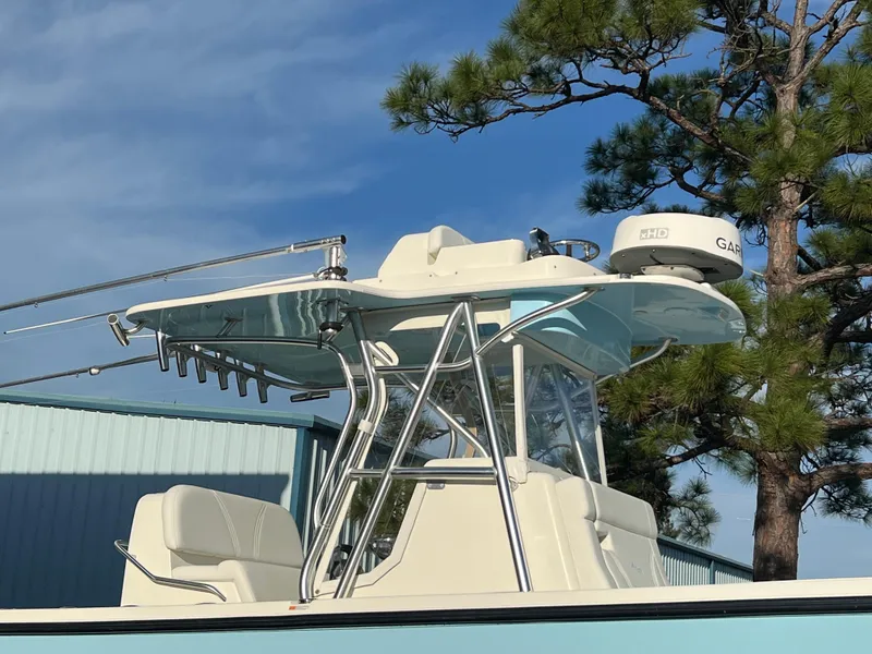 Slide: The Image of 2018 SeaVee 320B boat with radar, under clear blue sky and trees. - 16