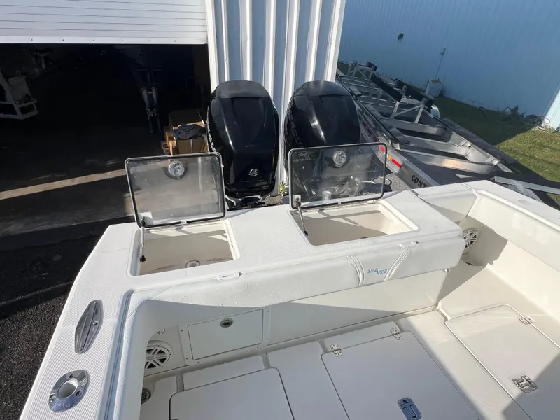 Slide: The Image of 2018 SeaVee 320B boat with dual outboard engines and open storage compartments. - 4