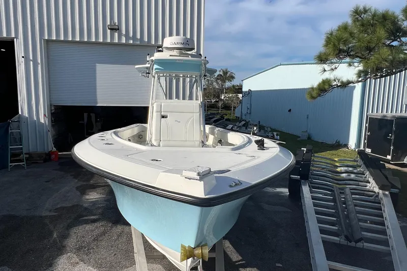 Slide: The Image of 2018 SeaVee 320B boat in front of a warehouse, featuring a light blue hull. - 5