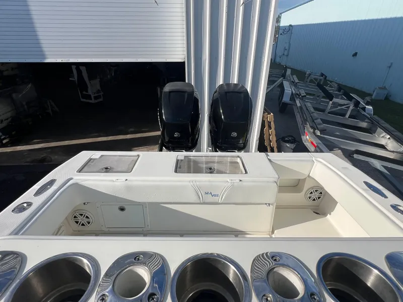 Slide: The Image of 2018 SeaVee 320B boat with dual outboard engines, docked near a warehouse. - 6