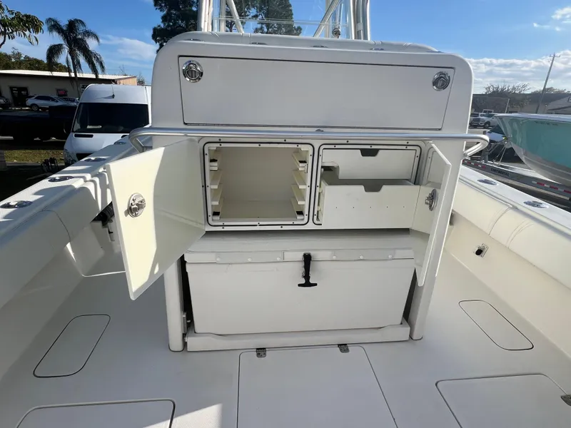Slide: The Image of 2018 SeaVee 320B boat interior with open storage compartments and cooler. - 9