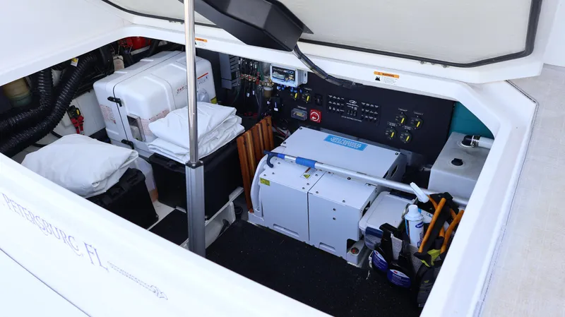 Slide: The Image of Engine compartment of 2023 Regal 36 XO boat, showcasing equipment and storage. - 10