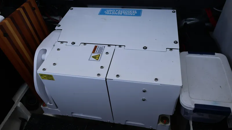 Slide: The Image of 2023 Regal 36 XO onboard generator in storage compartment. - 11