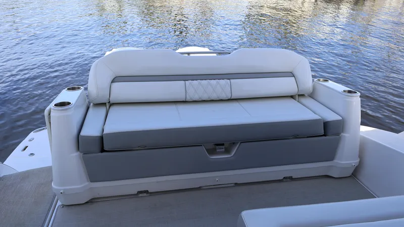 Slide: The Image of 2023 Regal 36 XO boat seating area with water backdrop. - 13