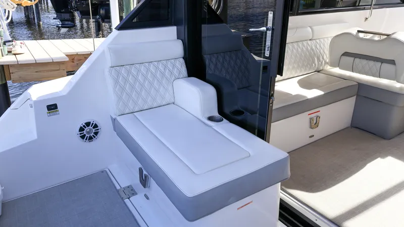 Slide: The Image of 2023 Regal 36 XO boat interior with white cushioned seating and modern design. - 16