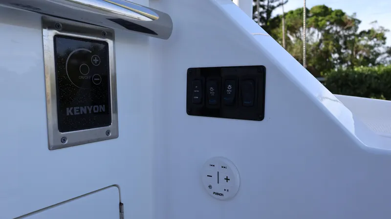 Slide: The Image of Control panel on 2023 Regal 36 XO boat, featuring Kenyon system and switches. - 20