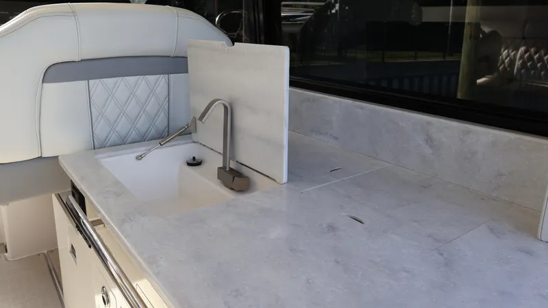 Slide: The Image of 2023 Regal 36 XO yacht interior with modern sink and countertop design. - 22