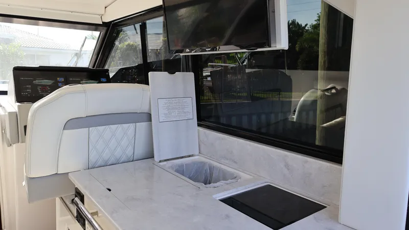 Slide: The Image of 2023 Regal 36 XO yacht interior with modern kitchen and seating area. - 23
