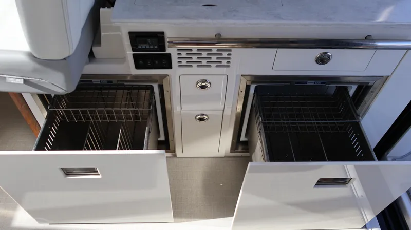 Slide: The Image of 2023 Regal 36 XO yacht kitchen with open storage drawers and modern design. - 25