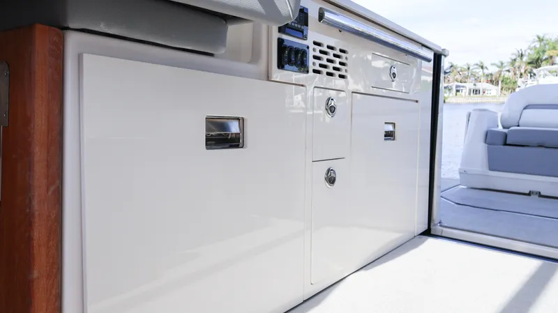 Slide: The Image of 2023 Regal 36 XO yacht interior, featuring sleek cabinetry and modern design elements. - 26