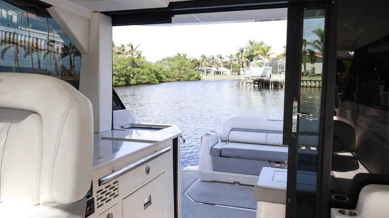 Slide: The Image of Interior view of 2023 Regal 36 XO yacht with open deck and waterfront scenery. - 27
