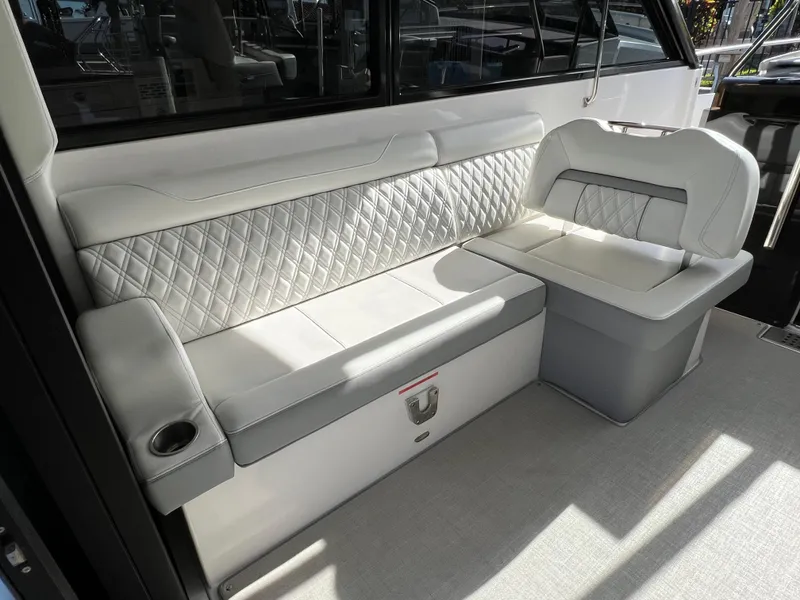 Slide: The Image of 2023 Regal 36 XO boat interior with elegant white seating and quilted backrest design. - 29