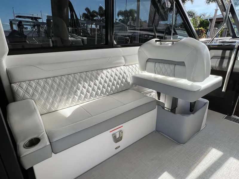 Slide: The Image of Luxurious interior seating of 2023 Regal 36 XO boat with quilted upholstery. - 30