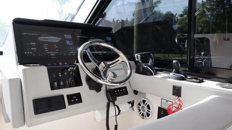 Slide: The Image of 2023 Regal 36 XO boat cockpit with modern controls and steering wheel. - 32