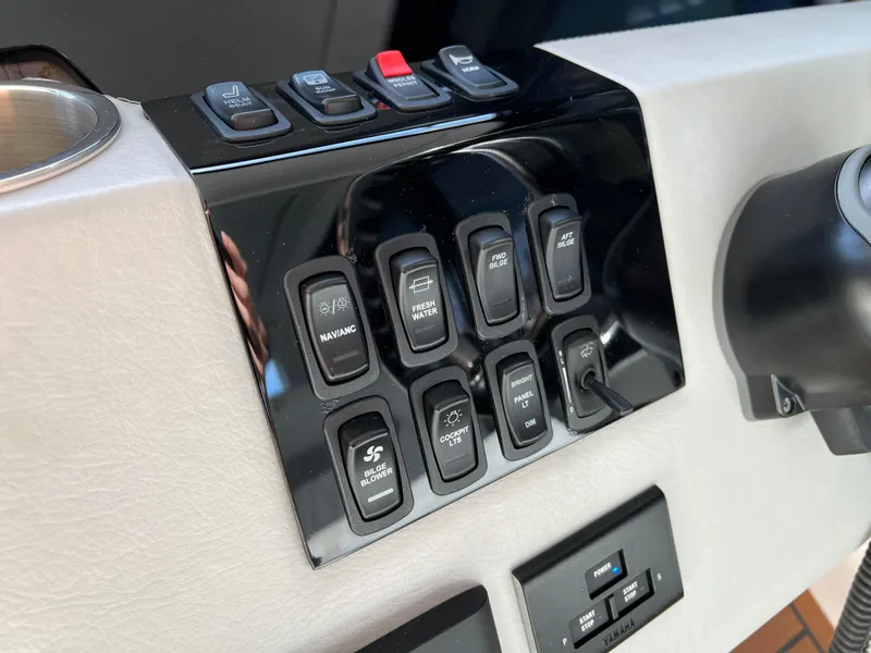Slide: The Image of Control panel of 2023 Regal 36 XO boat with various switches and buttons. - 35