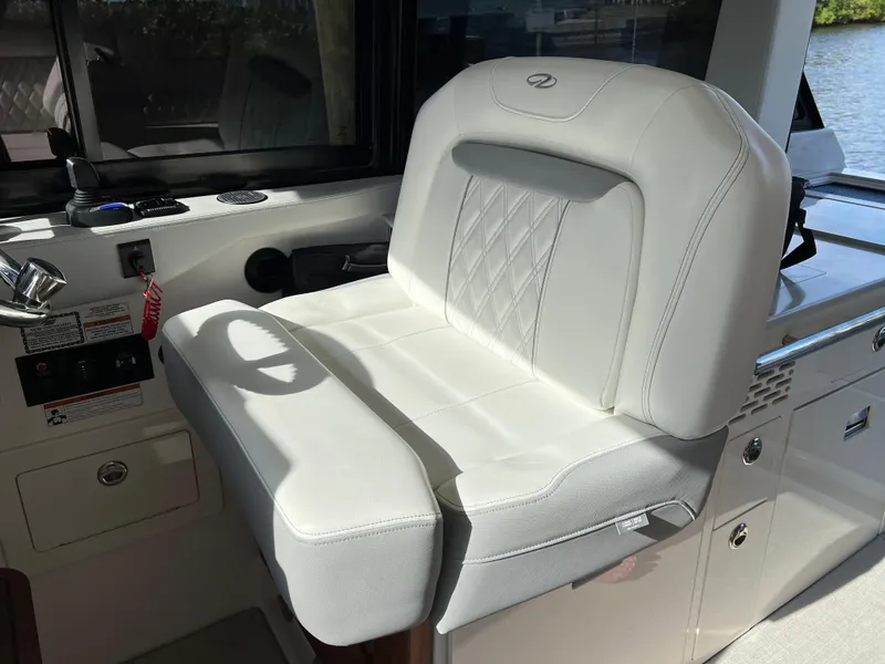 Slide: The Image of 2023 Regal 36 XO boat interior with luxurious white seating. - 36