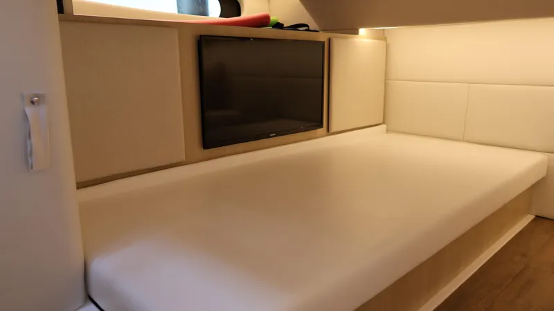 Slide: The Image of 2023 Regal 36 XO cabin interior with bed and wall-mounted TV. - 42
