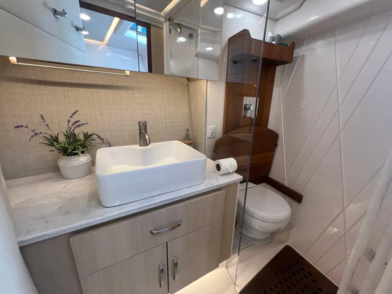 Slide: The Image of Luxurious bathroom in 2023 Regal 36 XO yacht, featuring modern sink and elegant decor. - 47
