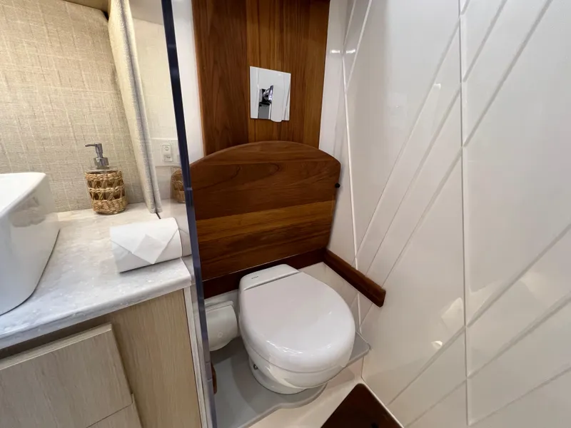 Slide: The Image of 2023 Regal 36 XO yacht bathroom with modern design, featuring wood accents and sleek fixtures. - 48