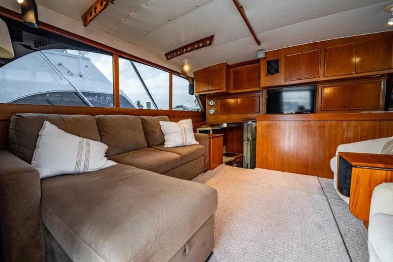 Slide: The Image of Luxurious interior of 1989 Post 43 Convertible yacht with plush seating and wooden cabinetry. - 10