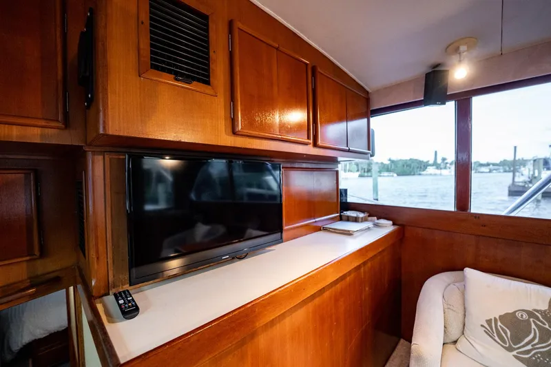 Slide: The Image of Interior of 1989 Post 43 Convertible yacht with wood paneling and TV. - 11