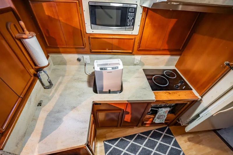 Slide: The Image of 1989 Post 43 Convertible kitchen with microwave, stove, and countertop appliances. - 13