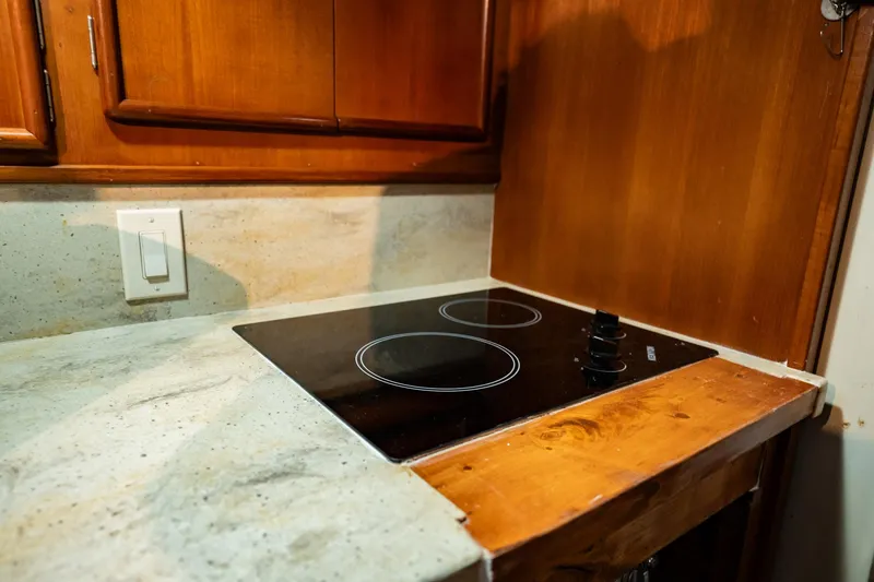 Slide: The Image of Compact kitchen with electric cooktop in 1989 Post 43 Convertible boat. - 15