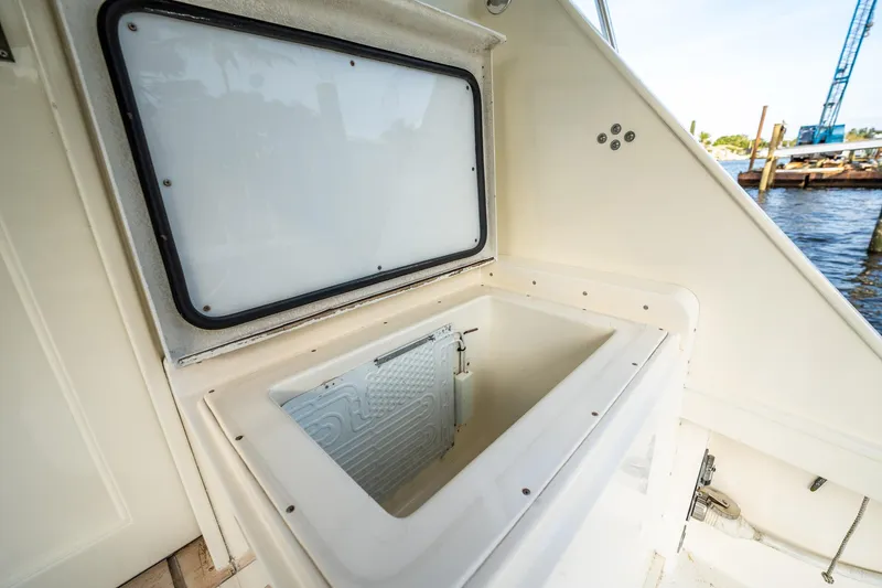 Slide: The Image of 1989 Post 43 Convertible boat interior storage compartment near water. - 21