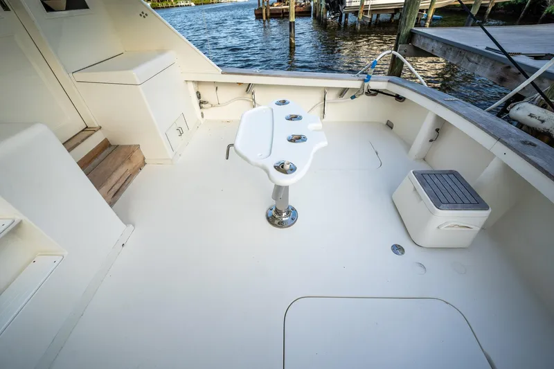 Slide: The Image of 1989 Post 43 Convertible boat deck with fishing station, near water. - 22