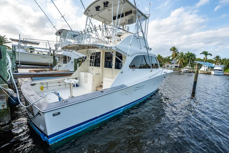 Slide: The Image of 1989 Post 43 Convertible yacht docked in marina, featuring sleek design and spacious deck. - 28