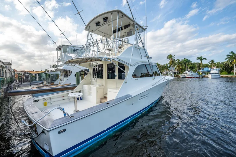 Slide: The Image of 1989 Post 43 Convertible yacht docked in a marina, featuring a spacious deck and flybridge. - 3