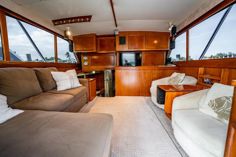 Slide: The Image of Luxurious interior of a 1989 Post 43 Convertible yacht with plush seating and wood paneling. - 4