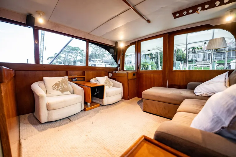 Slide: The Image of Interior of 1989 Post 43 Convertible yacht with cozy seating and wooden accents. - 5