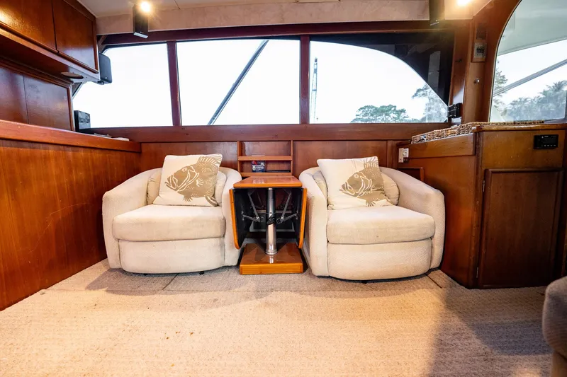 Slide: The Image of Interior of 1989 Post 43 Convertible yacht with cozy seating and wooden accents. - 6