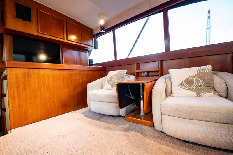 Slide: The Image of Interior of 1989 Post 43 Convertible yacht with cozy seating and wooden cabinetry. - 7