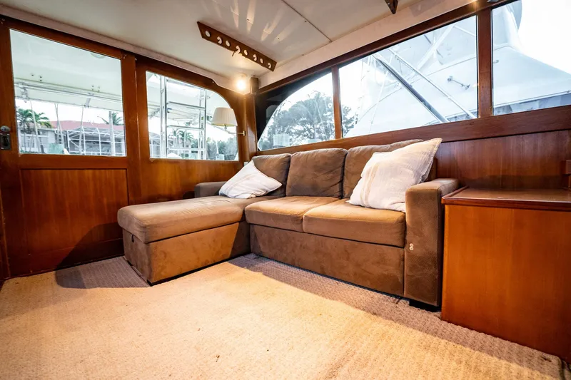 Slide: The Image of Interior of 1989 Post 43 Convertible yacht with cozy brown sofa and large windows. - 8