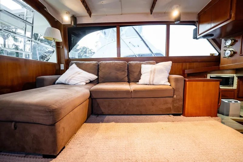 Slide: The Image of Interior of 1989 Post 43 Convertible yacht with cozy sofa and wooden accents. - 9