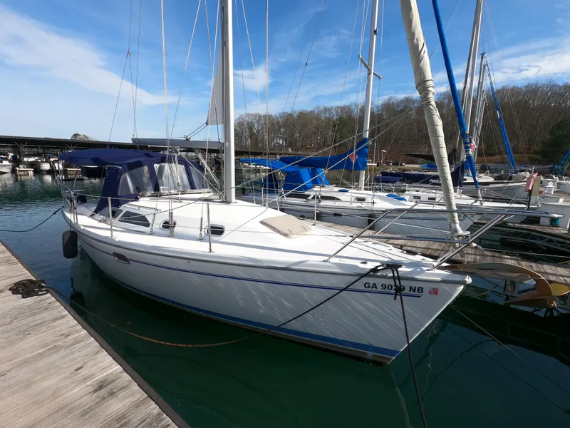The Image of Catalina 310 sailboat, 2002 model, docked at marina under clear blue sky. - 0