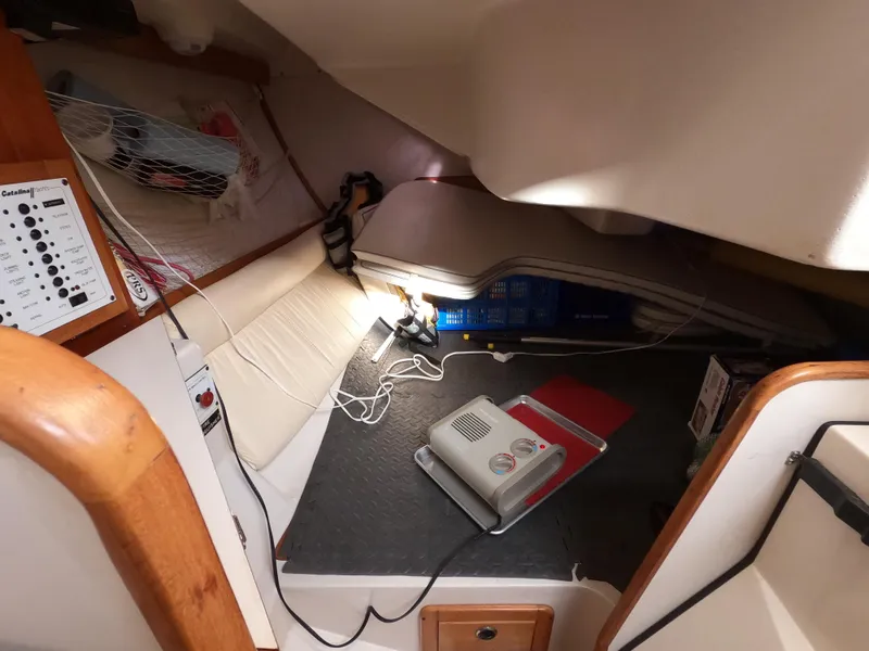 Slide: The Image of Interior cabin of a 2002 Catalina 310 sailboat with navigation equipment and storage. - 11