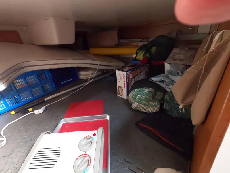 Slide: The Image of Storage area inside a 2002 Catalina 310 boat, featuring various items and equipment. - 12