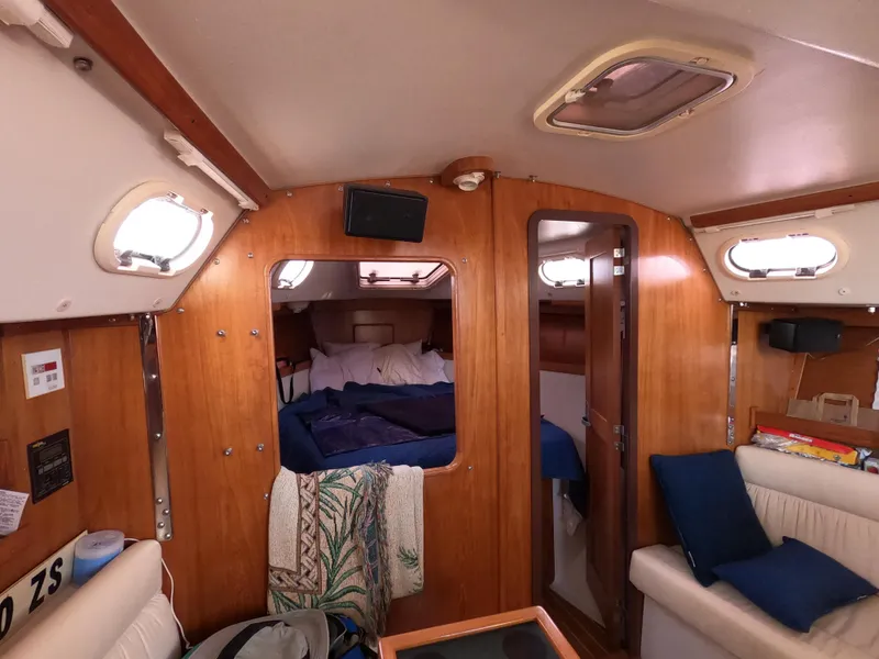 Slide: The Image of Interior of a 2002 Catalina 310 sailboat, featuring cozy cabin and wooden finishes. - 21