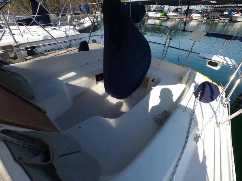 Slide: The Image of 2002 Catalina 310 sailboat cockpit with covered wheel, docked in marina. - 6