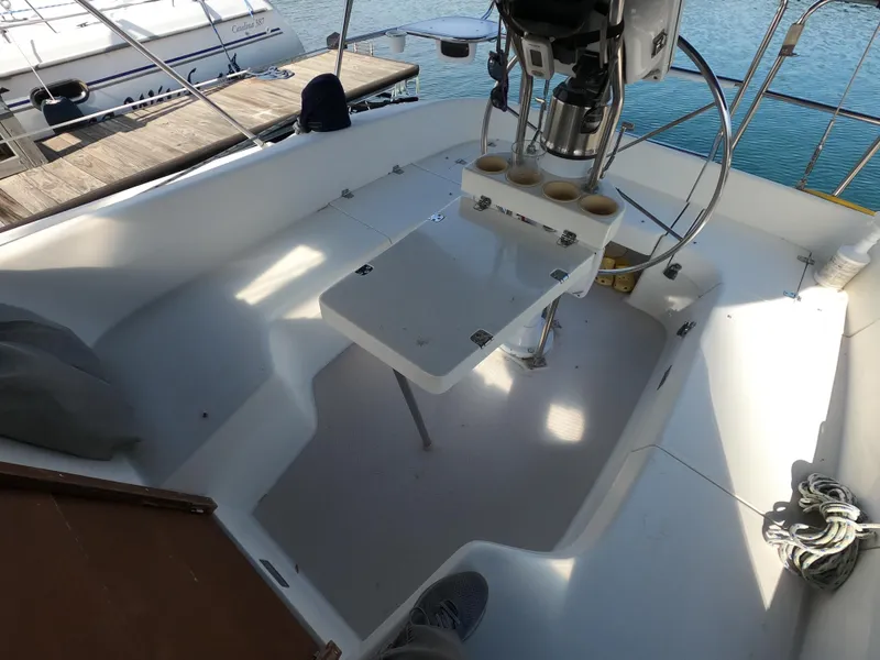 Slide: The Image of Cockpit of 2002 Catalina 310 sailboat with steering wheel and seating area. - 8