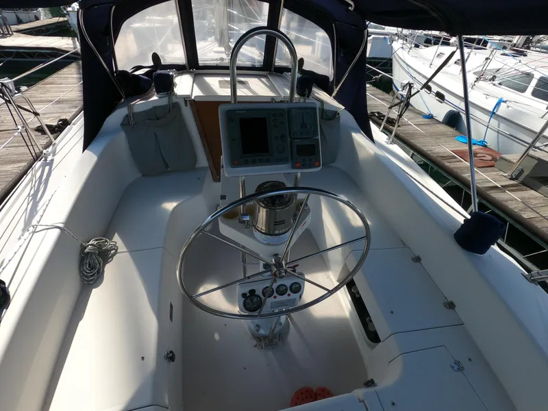 Slide: The Image of Cockpit of a 2002 Catalina 310 sailboat with steering wheel and navigation instruments. - 9