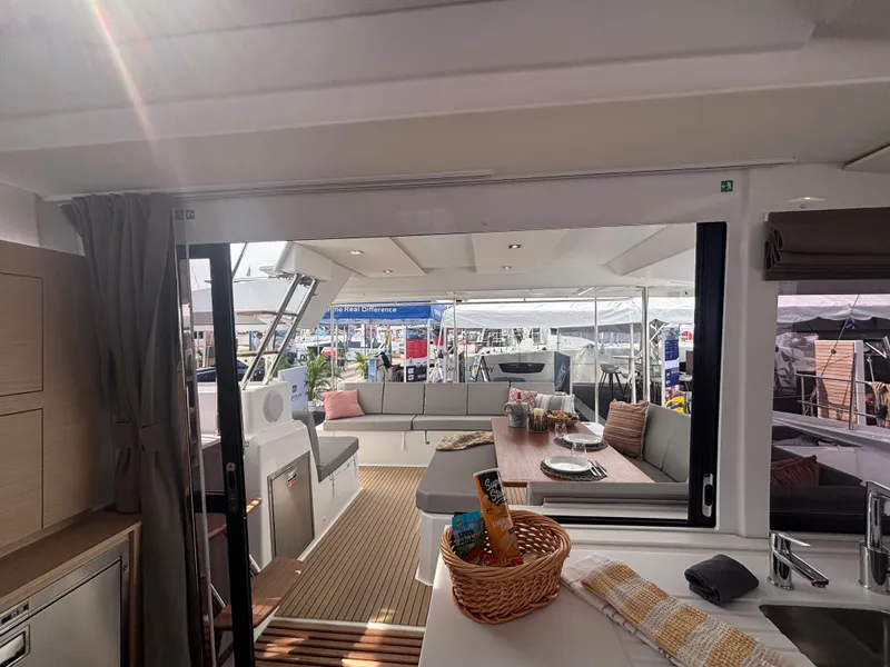 Slide: The Image of Interior view of 2025 Fountaine Pajot Astrea 42 catamaran, featuring spacious seating and dining area. - 19