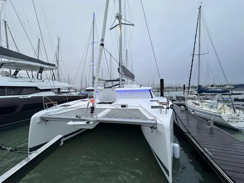 Slide: The Image of 2025 Fountaine Pajot Astrea 42 catamaran docked at a marina. - 21