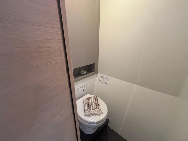 Slide: The Image of Compact bathroom in 2025 Fountaine Pajot Astrea 42 yacht, featuring modern toilet and minimalist design. - 33